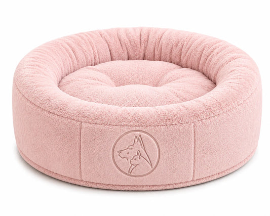 Soft pink pet bed with embossed dog logo on side, plush interior and exterior