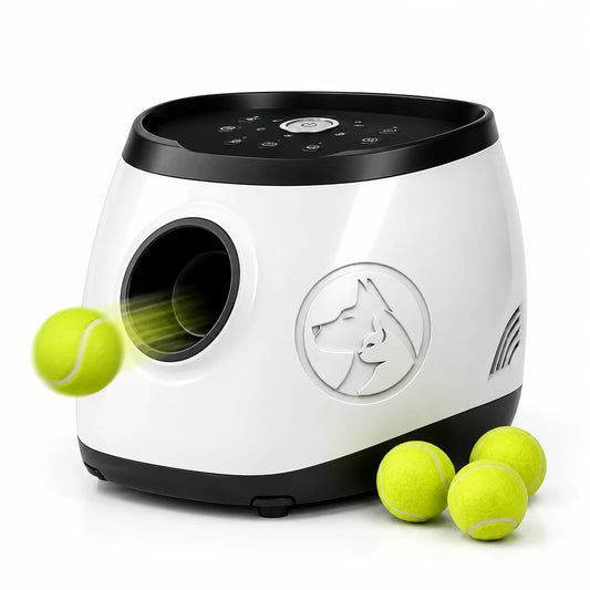 White and black dog treat and toy dispenser with tennis balls on plain background