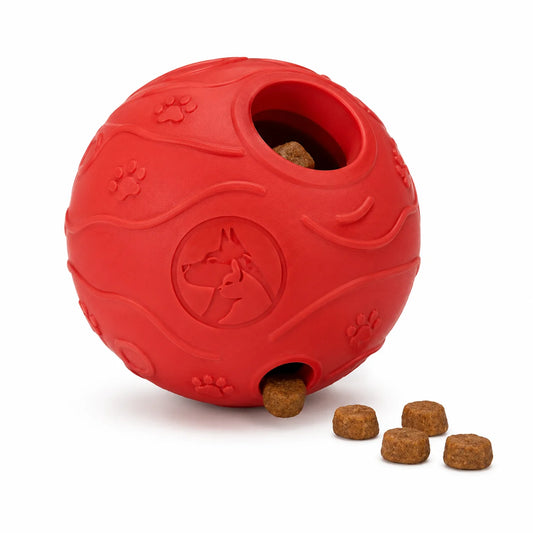 Red rubber dog toy ball with kibble and paw prints on white background
