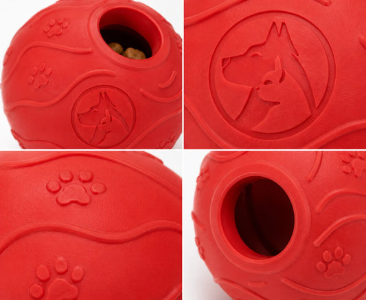 Red rubber dog toy with hole and paw prints on white background closeup